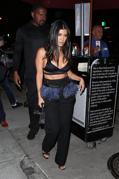 Kourtney Kardashian Pictures Kourtney Kardashian sexy cleavage in a black top seen by paparazzi.