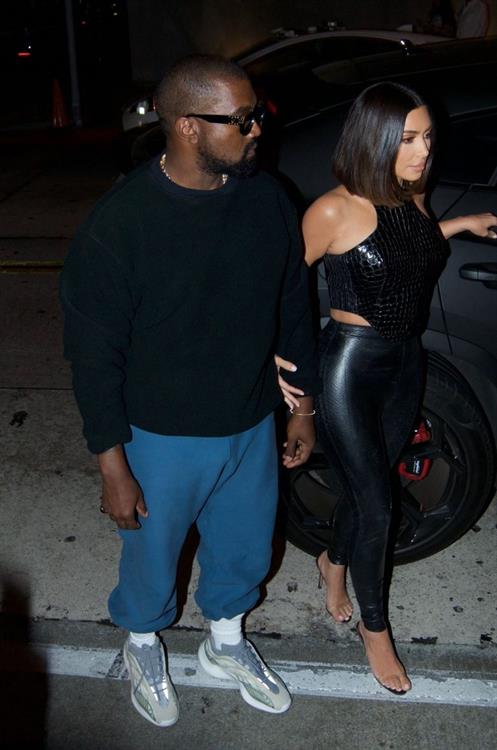 Kim Kardashian sexy in a tight leather outfit seen by paparazzi with her husband Kanye West.














