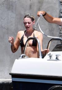 Kristen Stewart nude boobs caught topless by paparazzi tanning on a boat.
