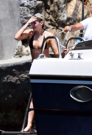 Kristen Stewart nude boobs caught topless by paparazzi tanning on a boat.
