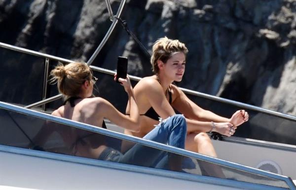 Kristen Stewart nude boobs caught topless by paparazzi tanning on a boat.
