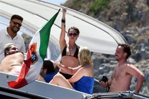 Kristen Stewart nude boobs caught topless by paparazzi tanning on a boat.
