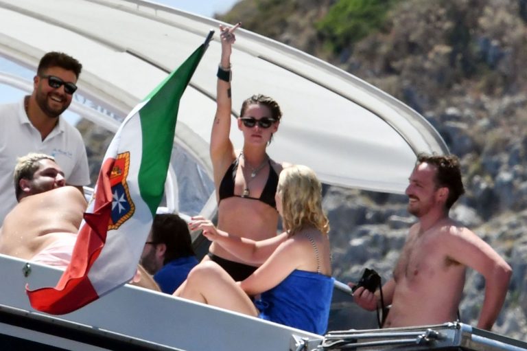 Kristen Stewart nude boobs caught topless by paparazzi tanning on a boat.
