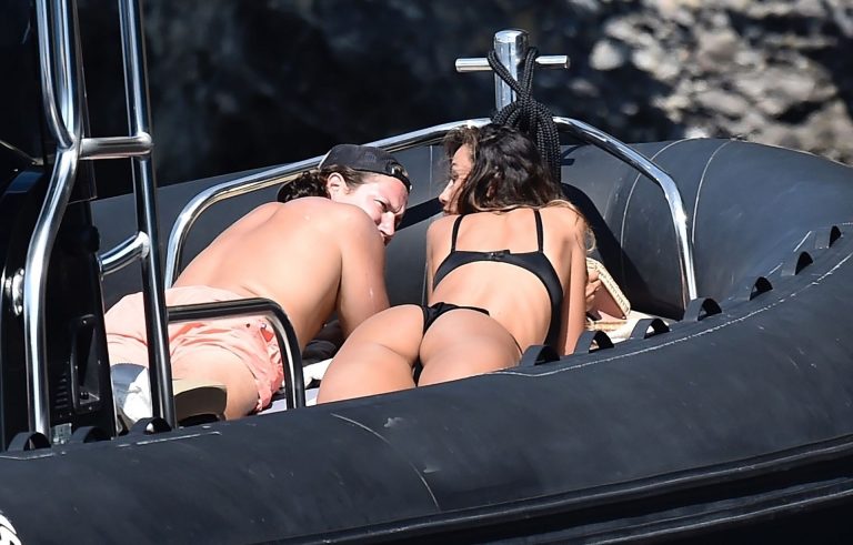 Madalina Diana Ghenea sexy ass and cleavage in a thong bikini seen by paparazzi.


