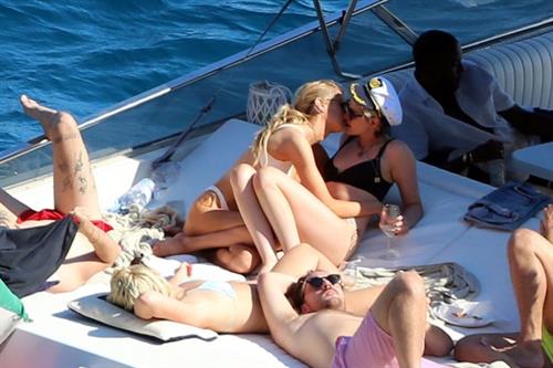 Kristen Stewart and Stella Maxwell sexy lesbians making out on a boat in bikinis seen by paparazzi.










