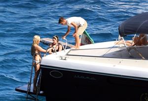 Kristen Stewart and Stella Maxwell sexy lesbians making out on a boat in bikinis seen by paparazzi.










