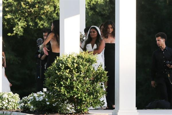 Selena Gomez sexy in a black dress for her cousins wedding showing nice cleavage seen by paparazzi.























