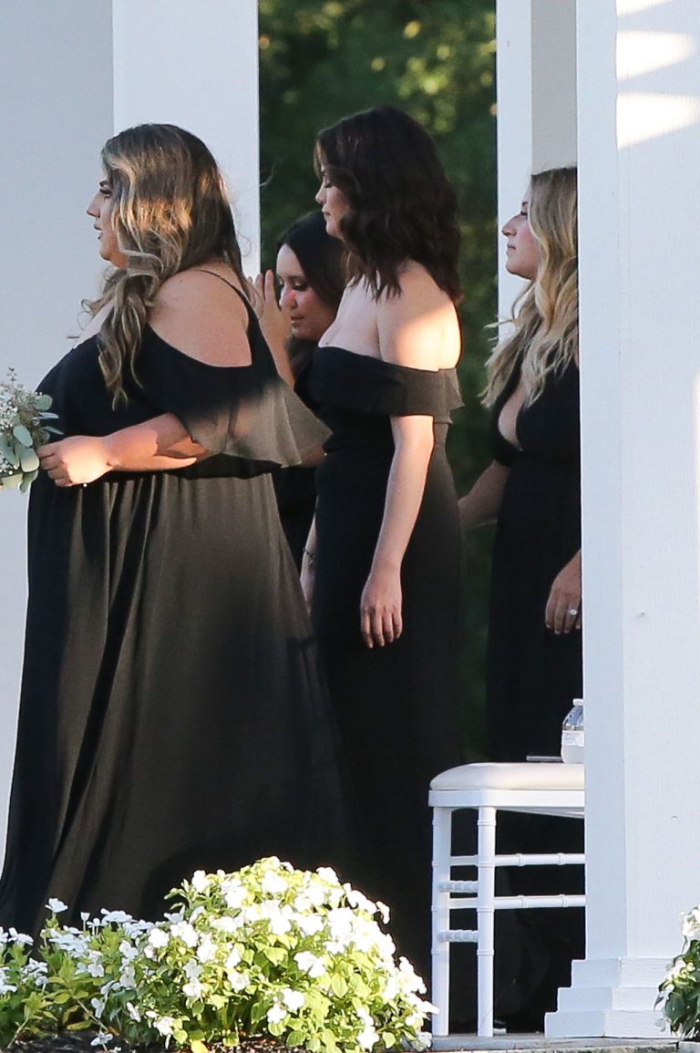 Selena Gomez Pictures Selena Gomez sexy in a black dress for her cousins wedding showing nice cleavage seen by paparazzi.