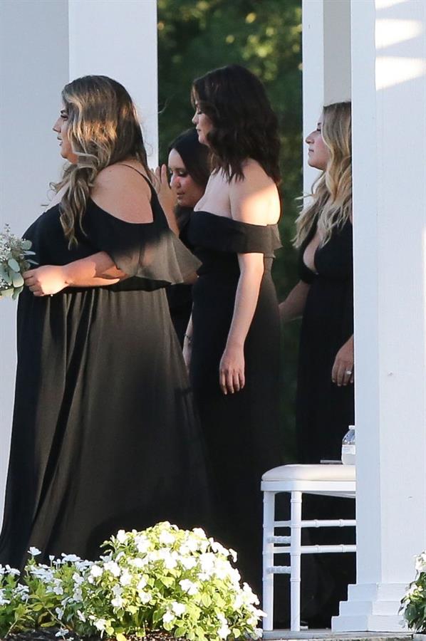 Selena Gomez sexy in a black dress for her cousins wedding showing nice cleavage seen by paparazzi.























