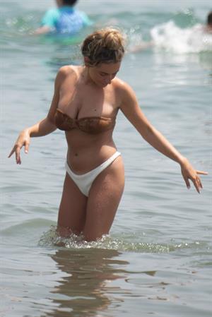 Amber Davies sexy boobs bouncing around in a loose bikini at the beach seen by paparazzi.

