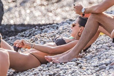 Alessandra Ambrosio Bikini Pictures Alessandra Ambrosio sexy at the beach in a thong bikini and flashing her pussy to her boyfriend seen by paparazzi.