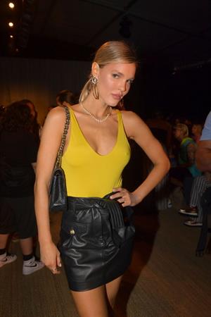 Joy Corrigan braless boobs in a yellow top showing her nipples pokies seen by paparazzi.













