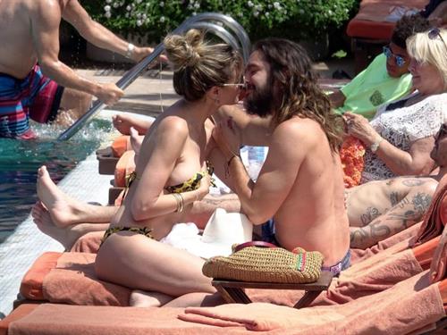 Heidi Klum Pictures Heidi Klum nip slip in a sexy bikini seen by paparazzi and kissing her husband and flashing her boob.