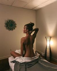 Josephine Skriver naked on a massage table.





