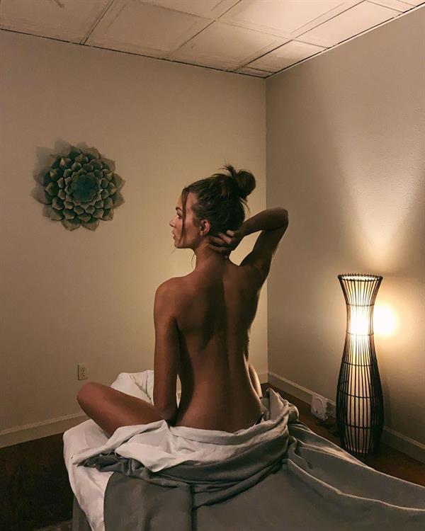 Josephine Skriver naked on a massage table.






