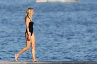 Sienna Miller nip slip wardrobe malfunction boobs popping out of her swimsuit caught by paparazzi.







