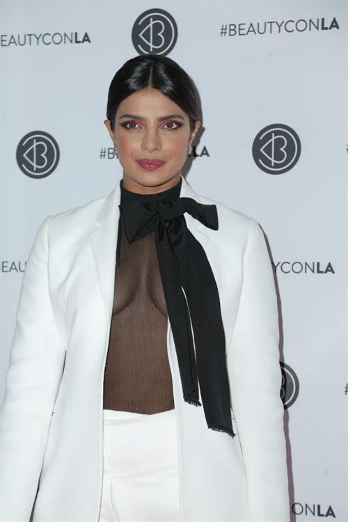 Priyanka Chopra Pictures Priyanka Chopra braless boobs in a see through top showing some nice cleavage at Beautycon.
