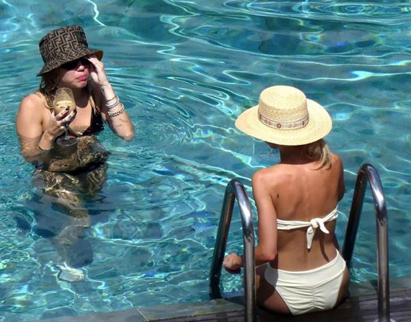 Miley Cyrus and Kaitlynn Carter making out kissing by the pool seen by paparazzi showing her lesbian side after leaving Liam Hemsworth.




