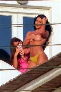 Martha Kalifatidis caught topless by paparazzi with her hand covering her nude big boobs.





