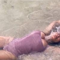 Salma Hayek big boobs showing nice cleavage wet in a swimsuit laying on the beach.

























