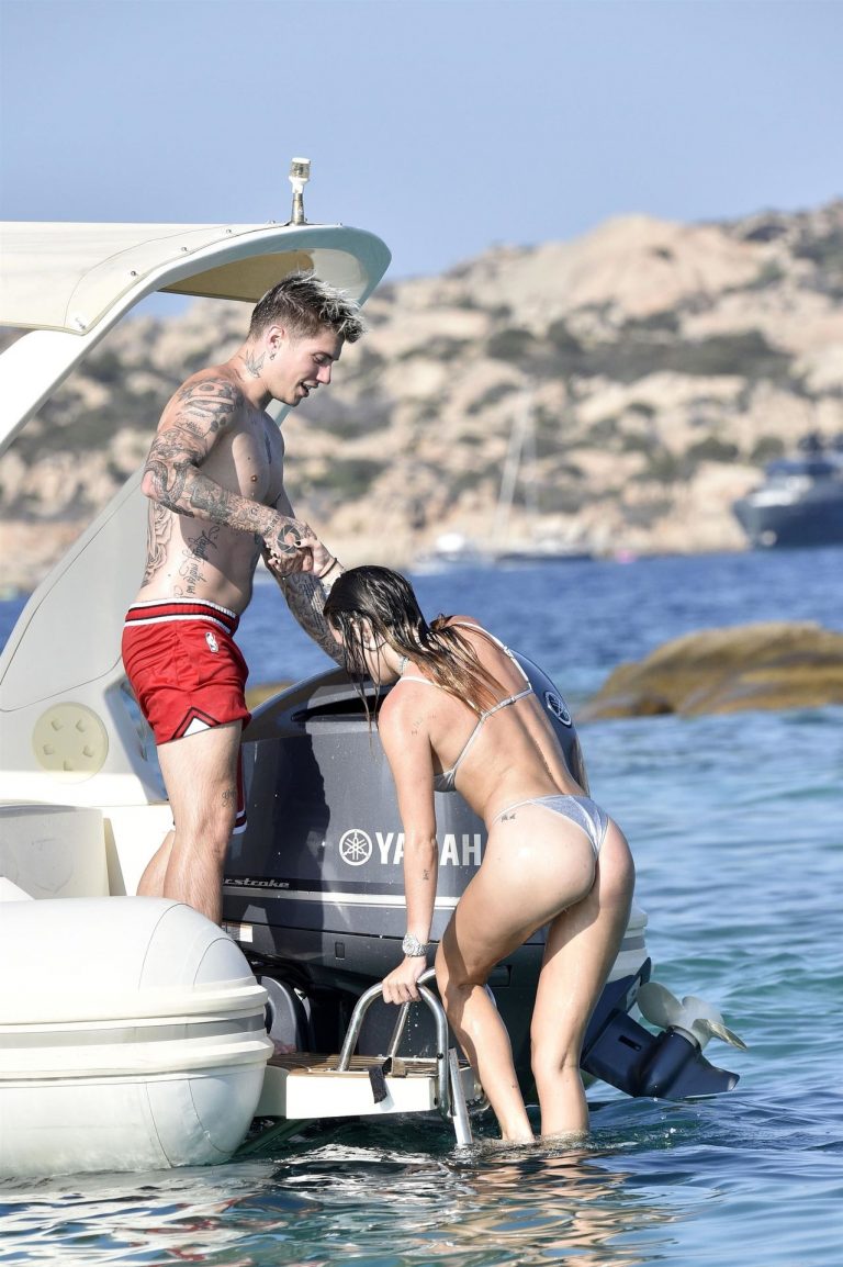 Bella Thorne Bikini Pictures Bella Thorne sexy in a thong bikini drinking and smoking weed out on the water showing off her ass seen by paparazzi.