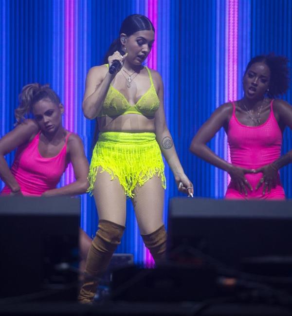 Mabel performing on stage singing in just a bra top showing off her boobs.
















