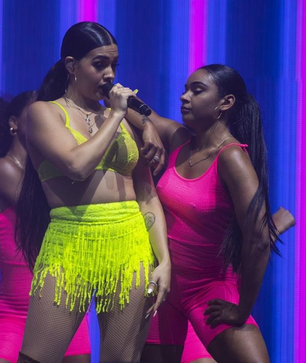 Mabel performing on stage singing in just a bra top showing off her boobs.
















