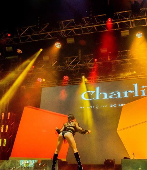 Charli XCX sexy ass on stage in a revealing outfit.

