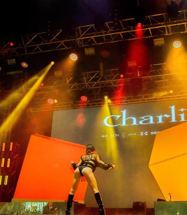 Charli XCX sexy ass on stage in a revealing outfit.

