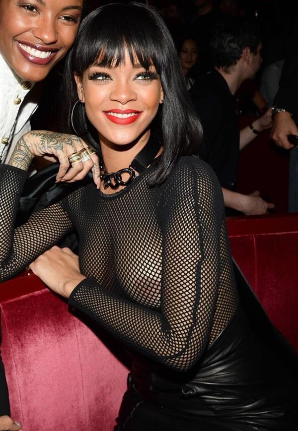 Rihanna braless boobs in a see through fishnet top showing off her tits and pierced nipple.




