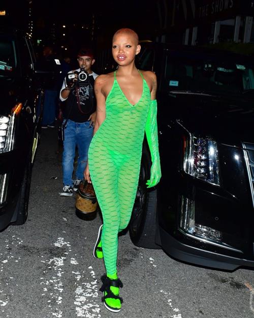 Slick Woods Pictures Slick Woods braless boobs in a see through dress showing off her tits and thong panties seen by paparazzi.