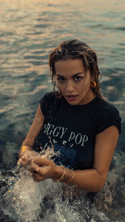 Rita Ora braless boobs in a wet t-shirt showing off her tits.




















