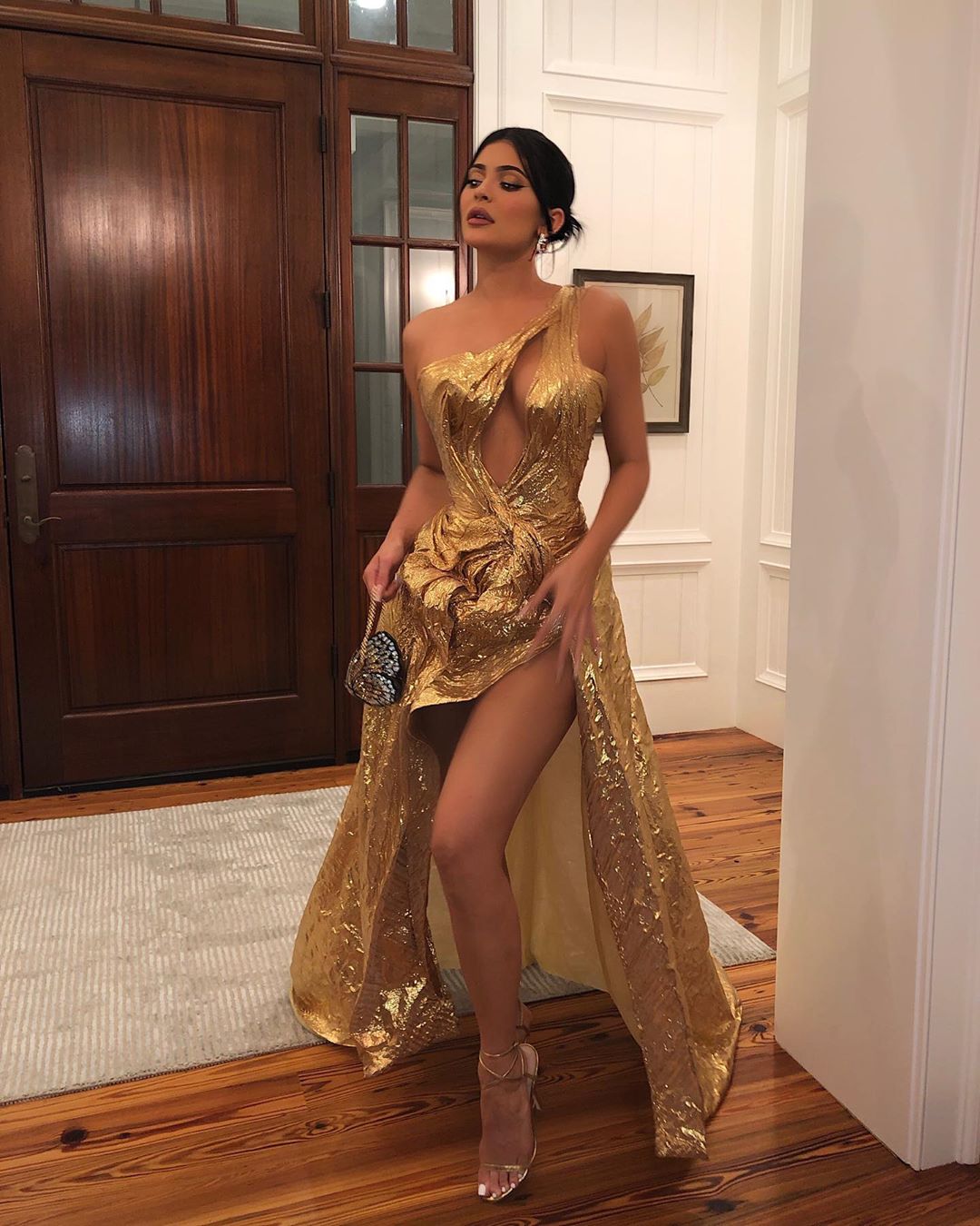 Kylie Jenner Pictures Kylie Jenner in sexy gold dress showing off her braless boobs cleavage going to Justin Bieber and Hailey Bieber's wedding.