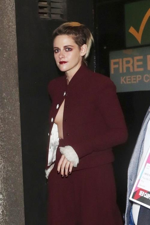 Kristen Stewart Pictures Kristen Stewart braless boobs with a top with only one button done up showing off her boobs seen by paparazzi.