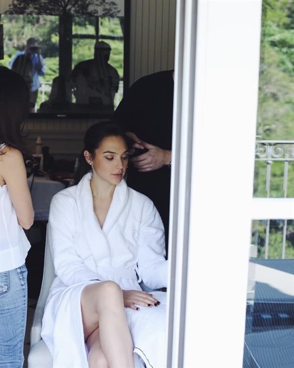 Gal Gadot sexy legs with a nice look up her robe while she is getting her hair done.
