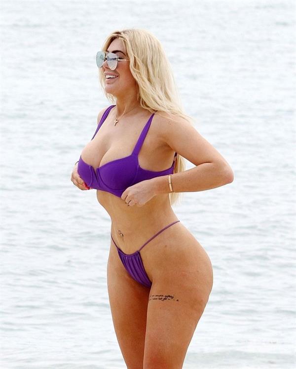 Chloe Ferry sexy ass in a thong bikini also showing nice cleavage and underboob with her big tits seen by paparazzi on the beach in Thailand.