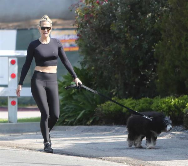 Molly Sims in a Crop Top and Leggings Walking Dog