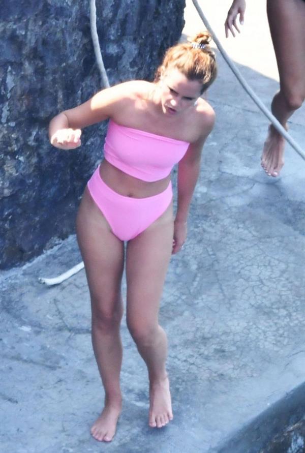 Emma Watson sexy ass in a little pink bikini seen by paparazzi in Italy with her hot friends showing off her tight model body.