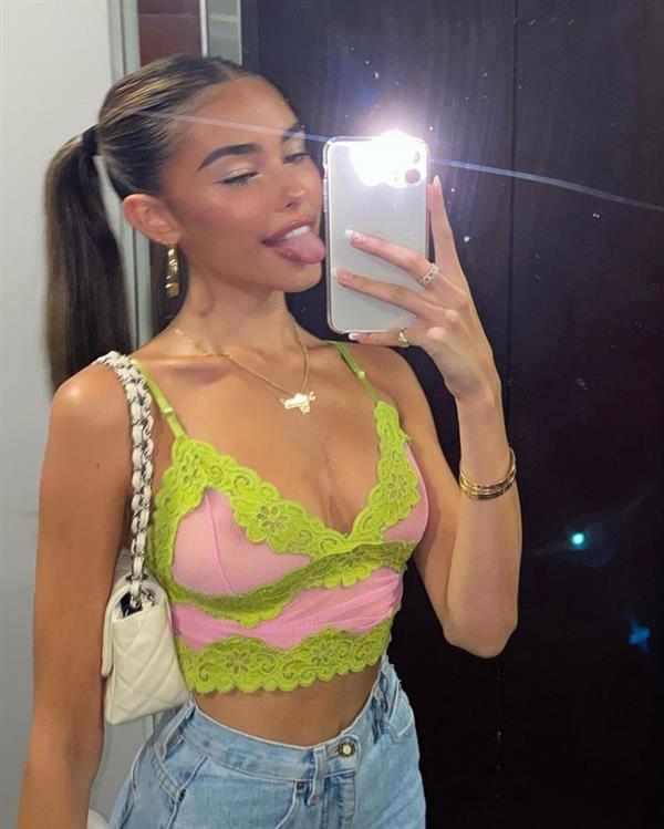 Madison Beer braless boobs in a see through sexy little top showing off her big tits and nice cleavage.
