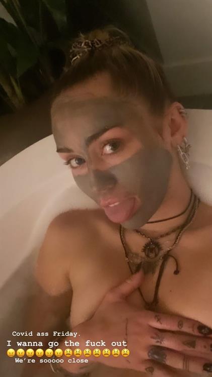 Miley Cyrus Pictures Miley Cyrus nude in the bath on a Friday night holding her topless big tits wanting to go out.