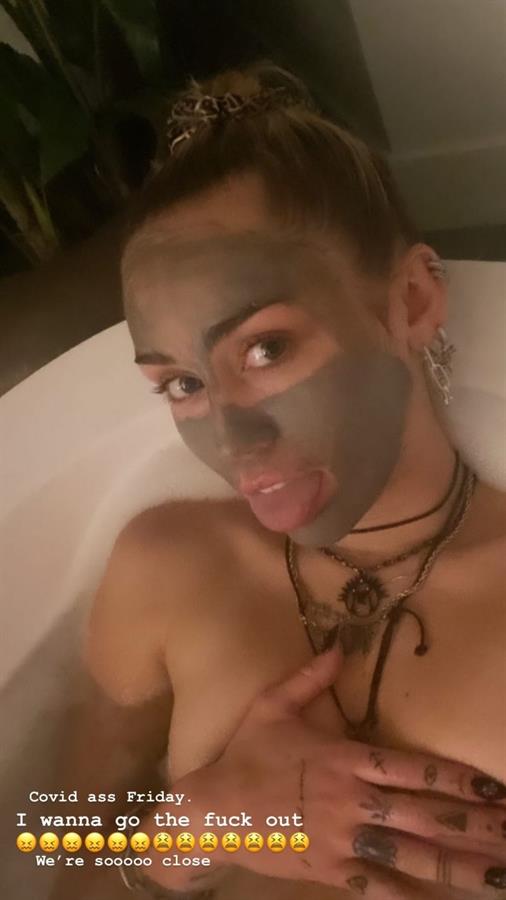 Miley Cyrus nude in the bath on a Friday night holding her topless big tits wanting to go out.