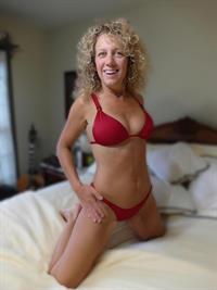 Sharon began her career as a nightclub stripper before moving into porn in her early 20's. She played minor roles in various porn films before retiring in her late 20's. She returned to the porn industry several years later as a poster girl for World Wide Wives and The Wives Club before expanding into Pornhub and TAC Amateurs a few years afterword. She currently maintains her TAC model page and continues to post to it regularly. Her curly blonde hair and petite body along with her sexual appetite have made her a favorite for years.