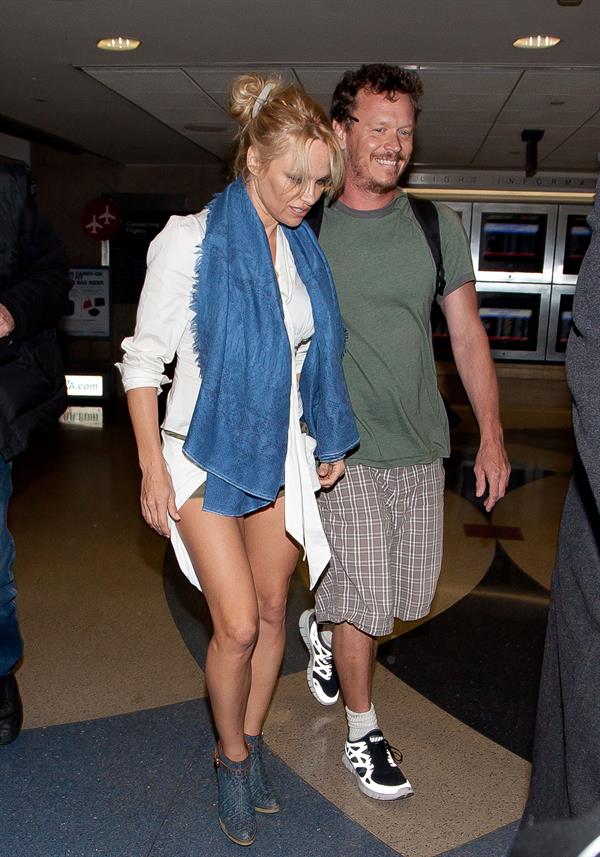Pamela Anderson shows some legs at Los Angeles International Airport on February 20, 2013